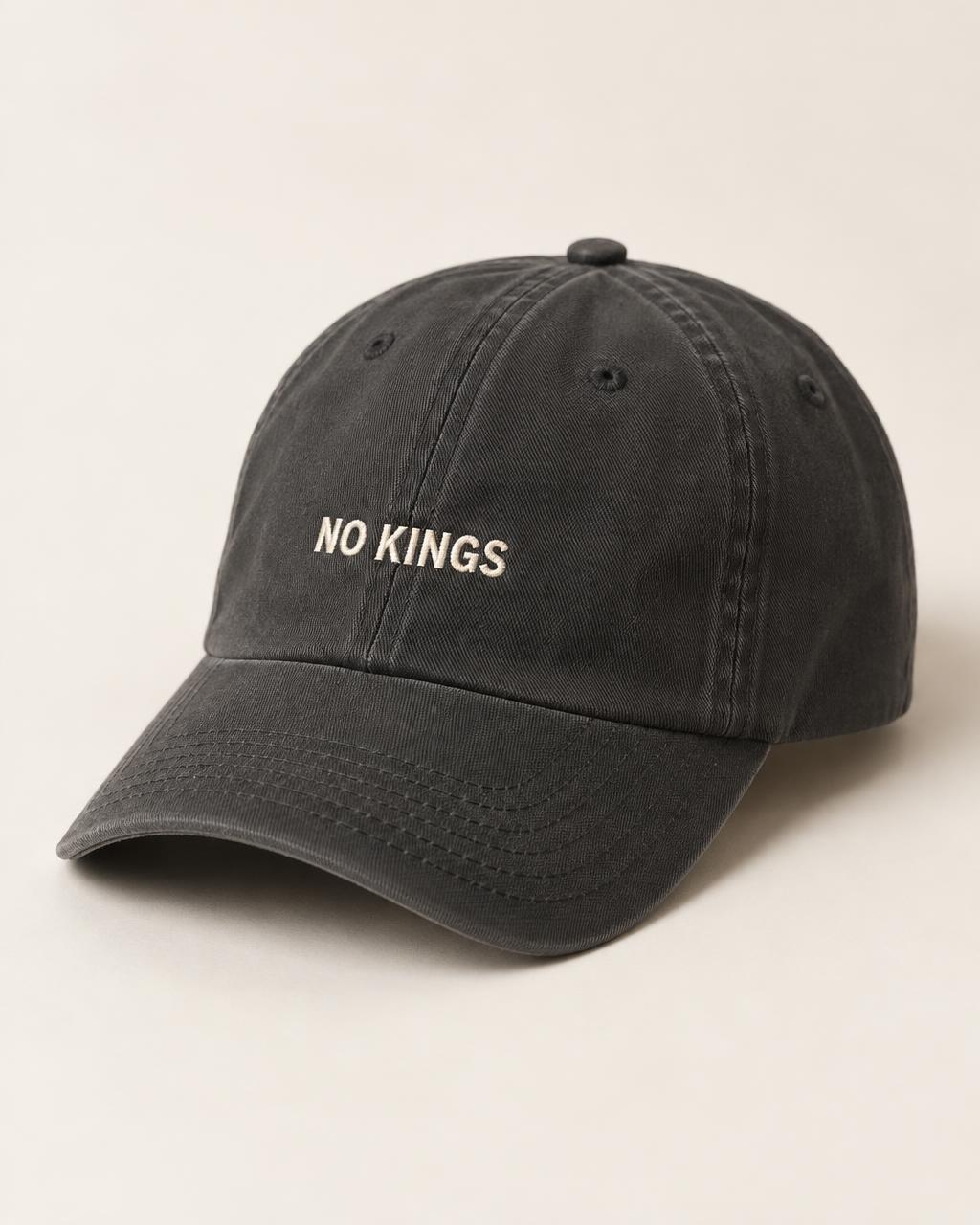 Concept mockup: charcoal cap with NO KINGS embroidered on the front
